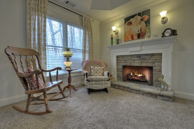 sitting room with ornamental molding, carpet floors, and a fireplace