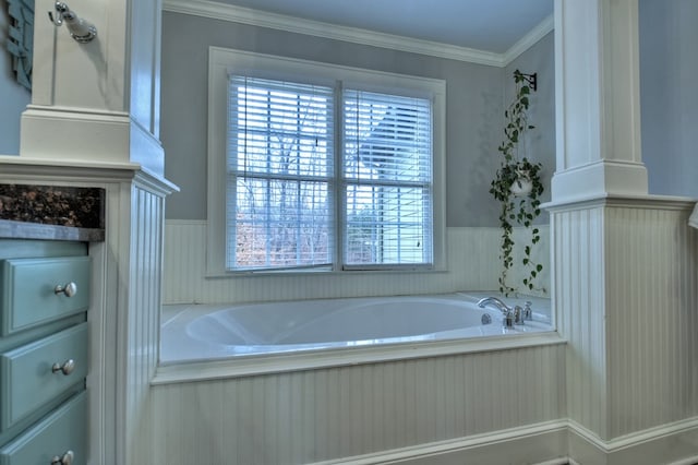 bathroom featuring crown molding and a bathing tub