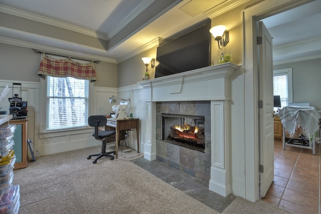 office space with a tile fireplace, crown molding, and carpet