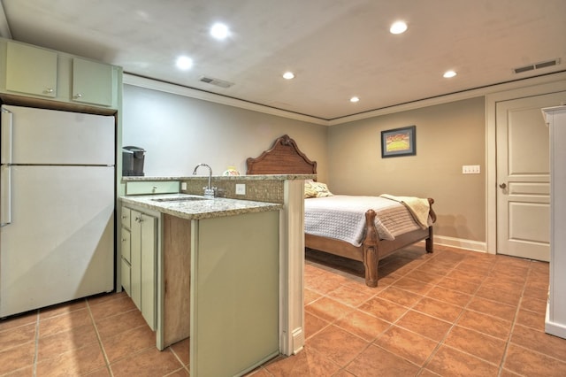 bedroom with white refrigerator, ornamental molding, and sink