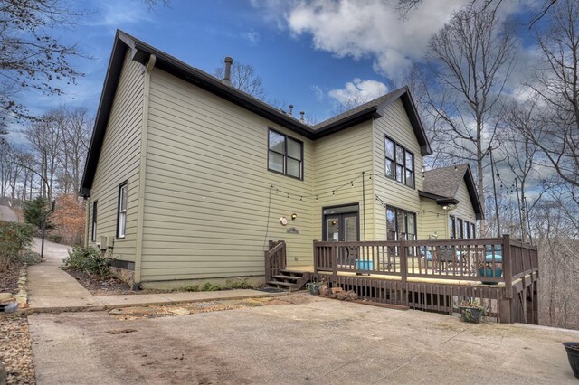 rear view of house with a wooden deck