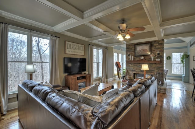 living room featuring coffered ceiling, beam ceiling, and ornamental molding