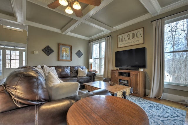 living room with beamed ceiling, crown molding, coffered ceiling, and ceiling fan