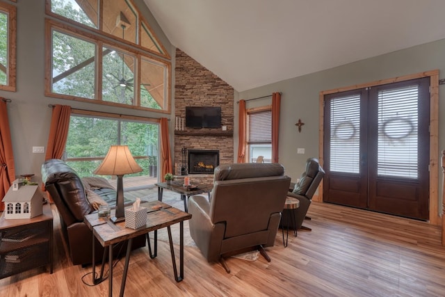 784 Sneaking Creek Dr, Hayesville, NC 28904 - living room with high vaulted ceiling, light wood-type flooring, and a stone fireplace