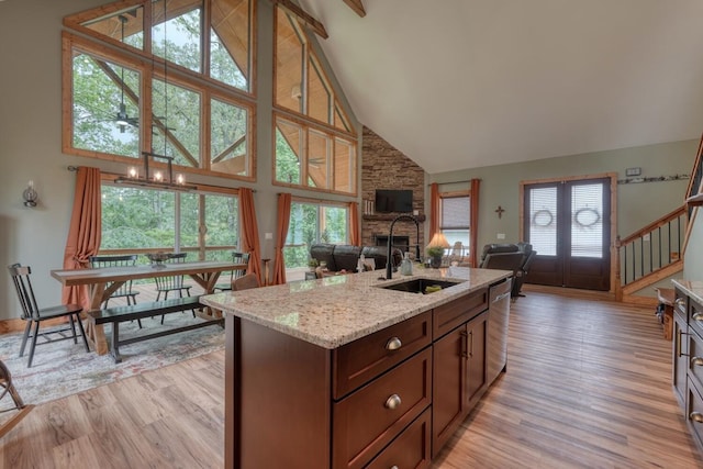 784 Sneaking Creek Dr, Hayesville, NC 28904 - kitchen featuring high vaulted ceiling, open floor plan, light wood-style flooring, light stone countertops, and an island with sink