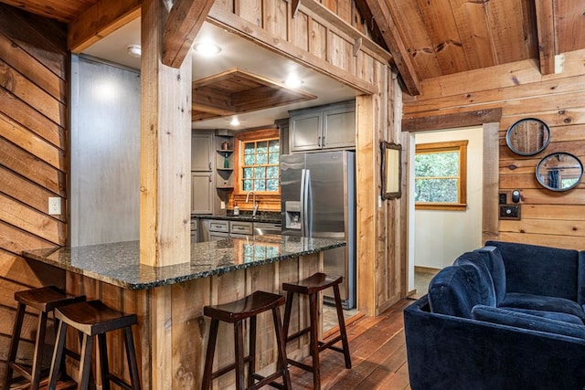 240 Donna Lee Ln, Mineral Bluff, GA 30559 - kitchen featuring stainless steel refrigerator with ice dispenser, wood ceiling, dark wood-style floors, wood walls, and a breakfast bar