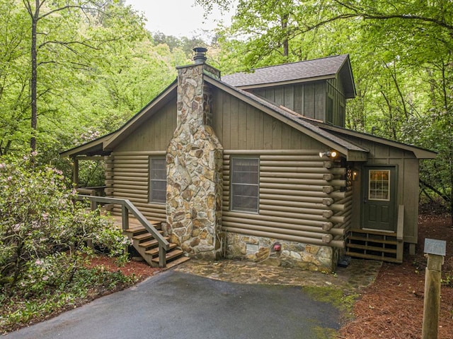 240 Donna Lee Ln, Mineral Bluff, GA 30559 - view of front of house featuring a chimney, log exterior, board and batten siding, and a forest view
