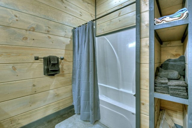 bathroom with shower / tub combo with curtain and wood walls