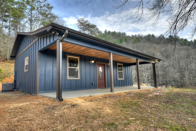 view of front facade with central AC and covered porch