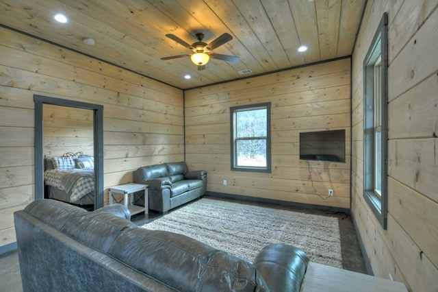 living room with wood ceiling, ceiling fan, and wood walls