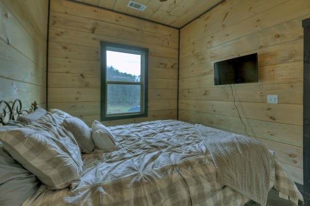 bedroom with wood ceiling and wooden walls