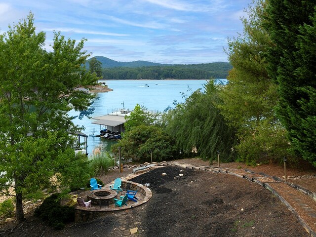 view of water feature with a fire pit and a mountain view