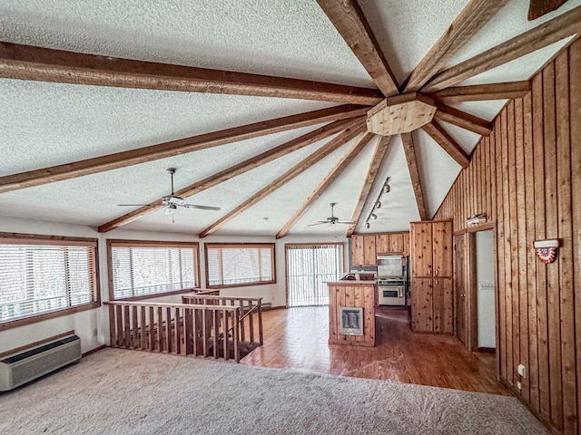 230 Tanglewood Dr, Blue Ridge, GA 30513 - kitchen with brown cabinets, lofted ceiling with beams, a textured ceiling, a wall unit AC, and ceiling fan