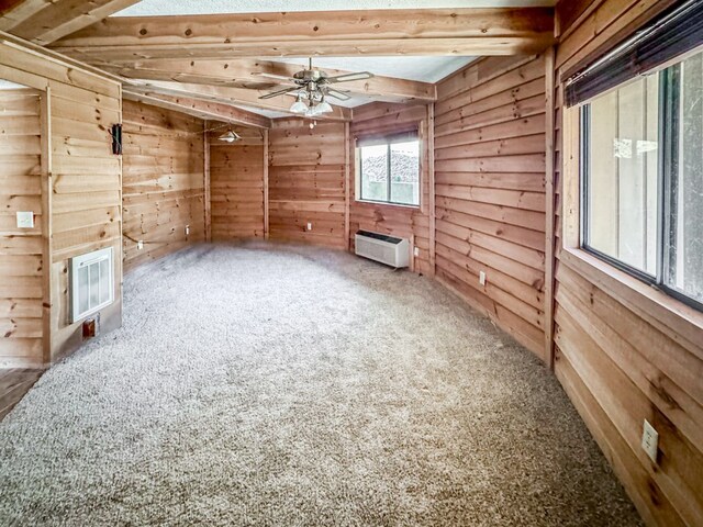 230 Tanglewood Dr, Blue Ridge, GA 30513 - carpeted spare room featuring beam ceiling, wooden walls, ceiling fan, and a wall mounted AC