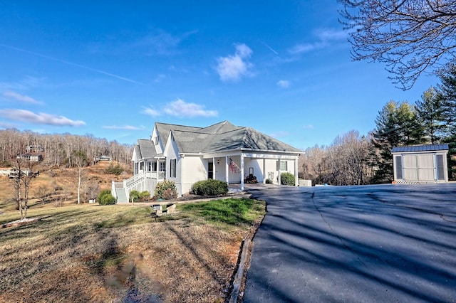 view of home's exterior featuring a storage unit and a lawn