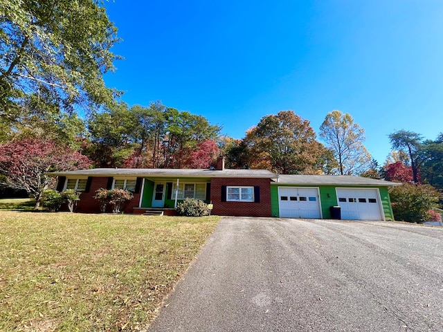 136 Ashe Knob Dr, Hayesville, NC 28904 - ranch-style house featuring an attached garage, asphalt driveway, a front yard, a chimney, and covered porch