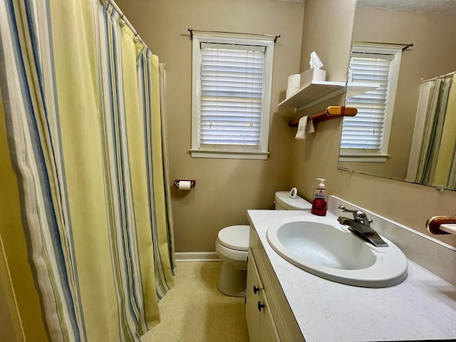 bathroom featuring toilet, curtained shower, and vanity