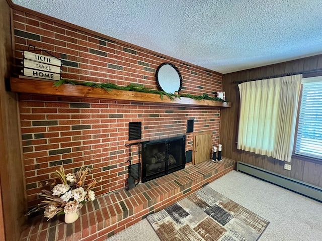 unfurnished living room featuring a textured ceiling, a baseboard heating unit, a brick fireplace, and carpet flooring