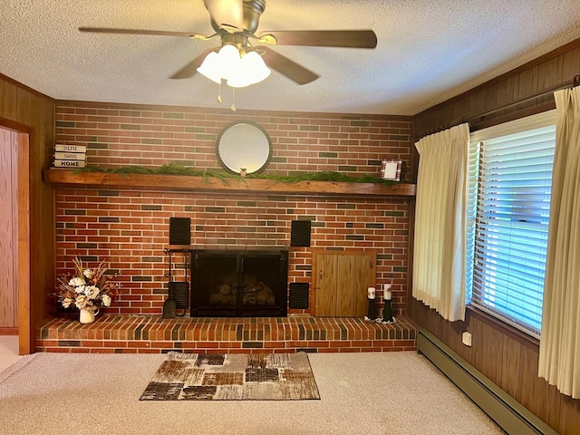 136 Ashe Knob Dr, Hayesville, NC 28904 - living area with a baseboard radiator, wood walls, a brick fireplace, a textured ceiling, and carpet floors