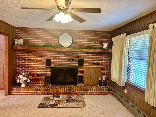 carpeted living room with wood walls, a wealth of natural light, and baseboard heating