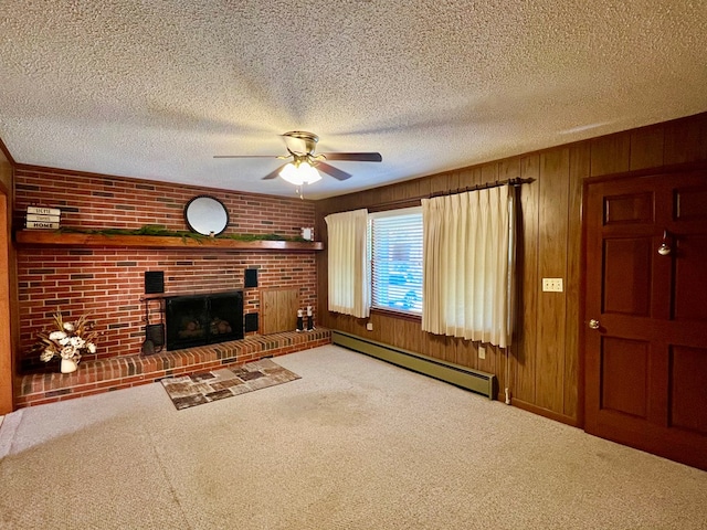 unfurnished living room featuring a baseboard heating unit, a textured ceiling, a fireplace, and carpet floors