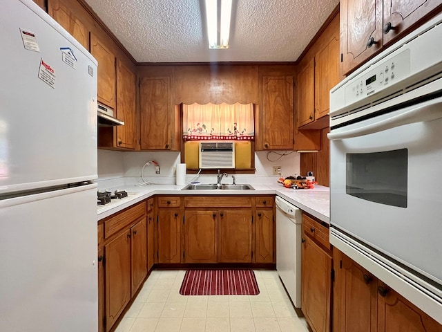 136 Ashe Knob Dr, Hayesville, NC 28904 - kitchen with white appliances, a textured ceiling, a sink, brown cabinetry, and light countertops