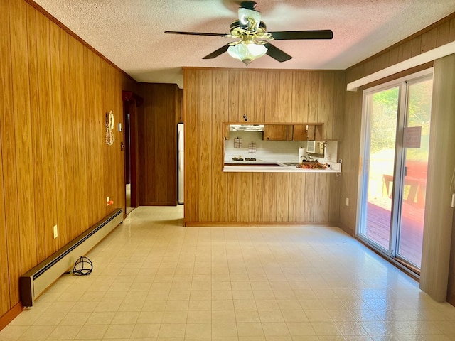 136 Ashe Knob Dr, Hayesville, NC 28904 - kitchen featuring wooden walls, a baseboard heating unit, a textured ceiling, light countertops, and ceiling fan