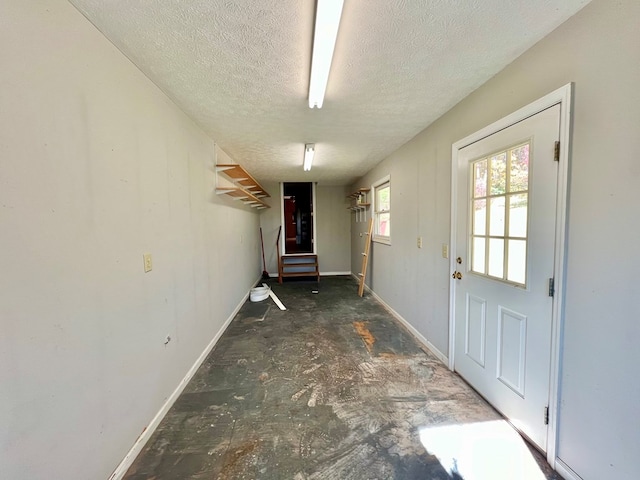 doorway with a textured ceiling