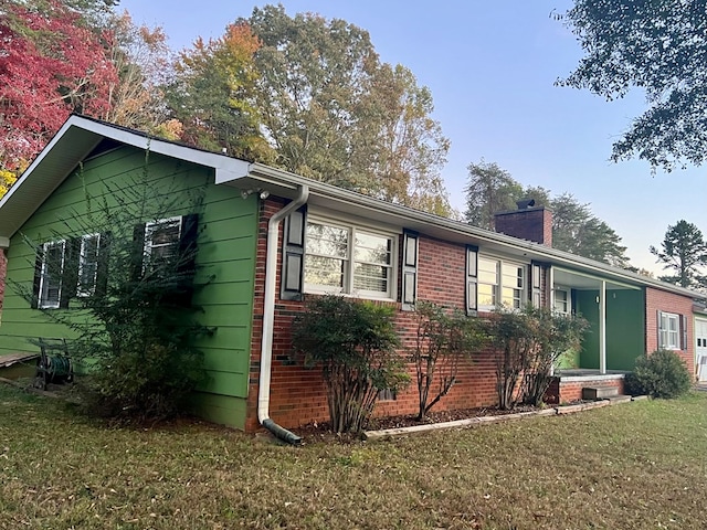 136 Ashe Knob Dr, Hayesville, NC 28904 - view of side of home with a yard, a chimney, and brick siding