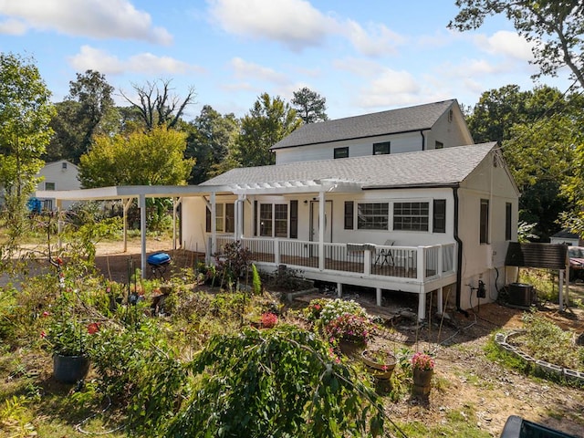 rear view of property featuring a wooden deck and cooling unit