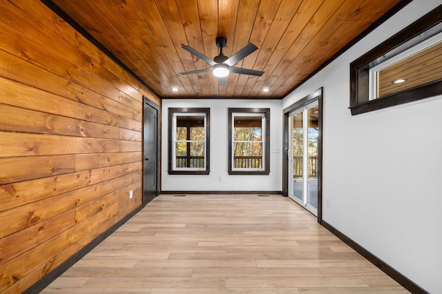 corridor featuring light hardwood / wood-style flooring, wood ceiling, and wood walls