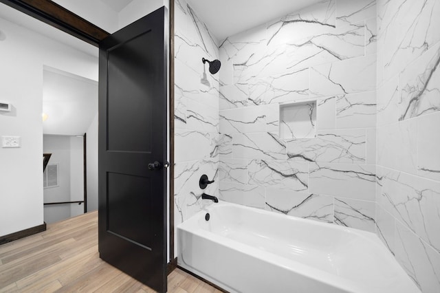 bathroom with tiled shower / bath and hardwood / wood-style flooring