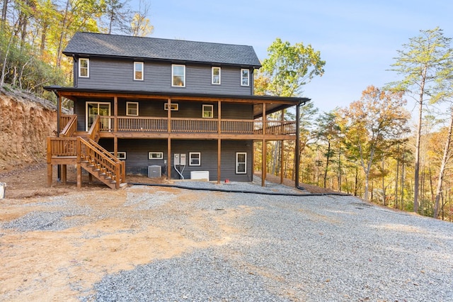 back of house featuring a wooden deck