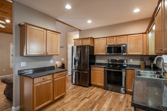 kitchen featuring appliances with stainless steel finishes, recessed lighting, a sink, and light wood finished floors