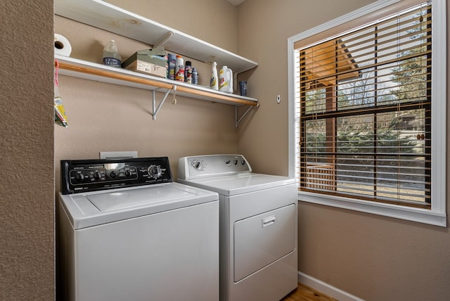 laundry room featuring laundry area, baseboards, and washer and clothes dryer