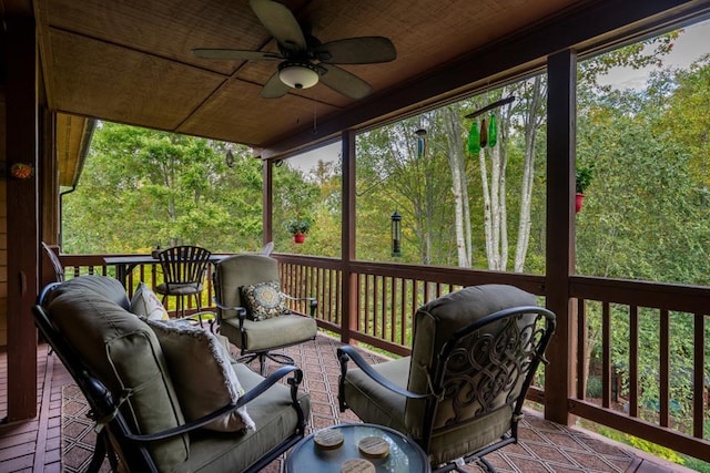 wooden deck featuring an outdoor living space and a ceiling fan