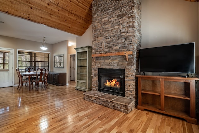 unfurnished living room with high vaulted ceiling, a fireplace, wood finished floors, and wooden ceiling