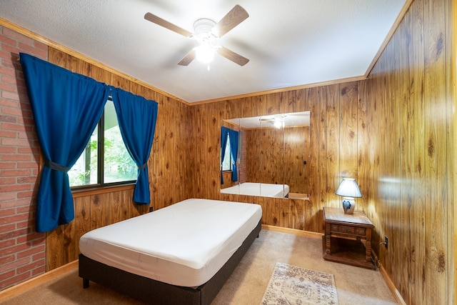 bedroom featuring light carpet, crown molding, ceiling fan, and wooden walls