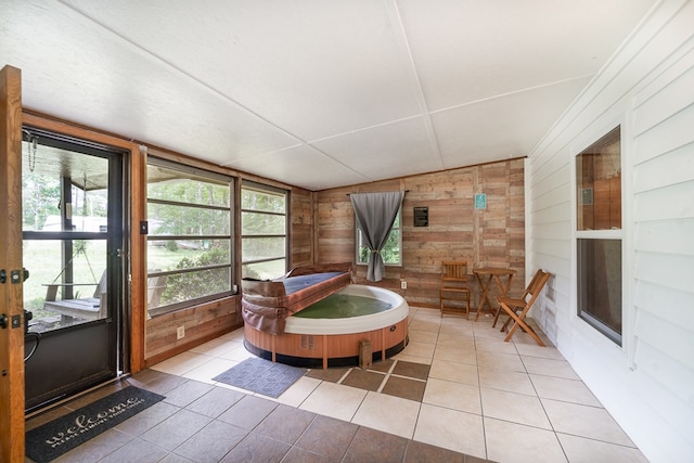 sunroom featuring a jacuzzi and lofted ceiling