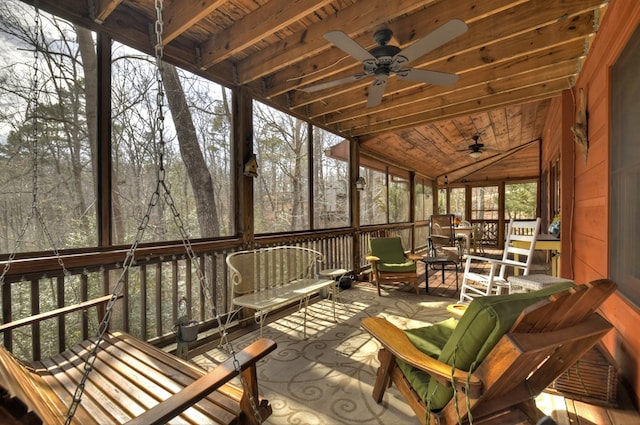 sunroom featuring wood ceiling, lofted ceiling, and a ceiling fan