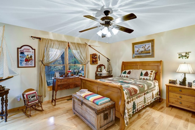 bedroom featuring baseboards, light wood-type flooring, and ceiling fan