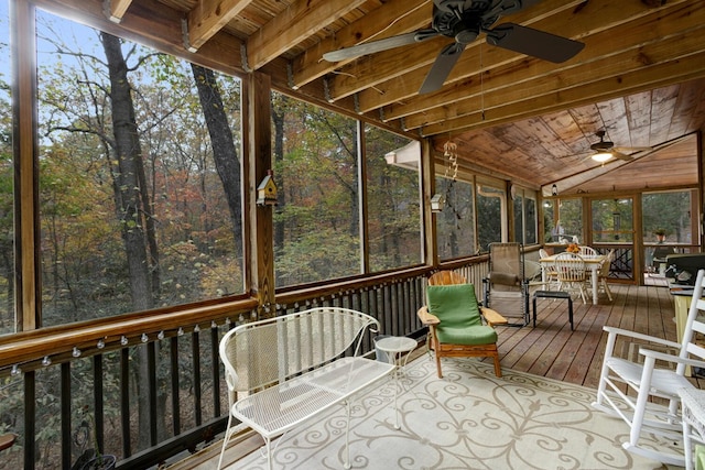 sunroom / solarium with vaulted ceiling, plenty of natural light, wood ceiling, and ceiling fan