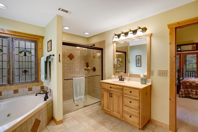 ensuite bathroom featuring vanity, visible vents, ensuite bath, a whirlpool tub, and a shower stall