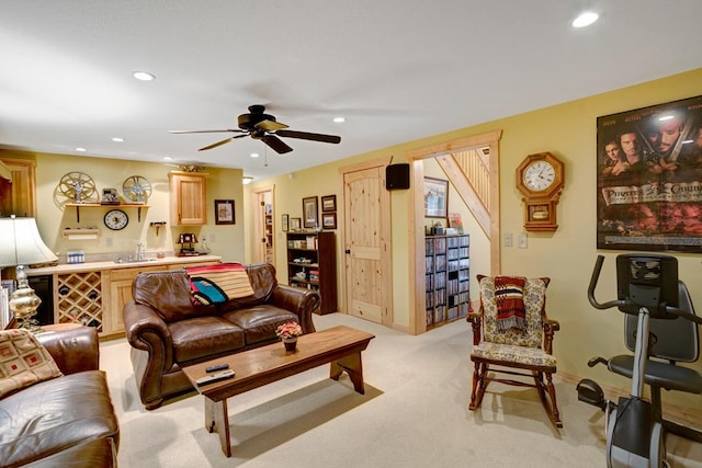 living area featuring a ceiling fan, recessed lighting, light colored carpet, and baseboards