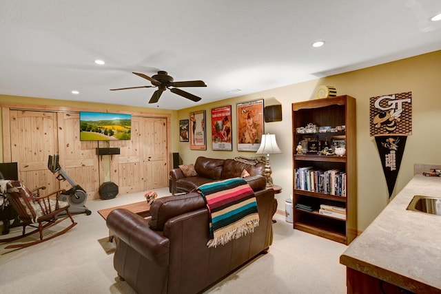 living room with recessed lighting, a ceiling fan, and carpet