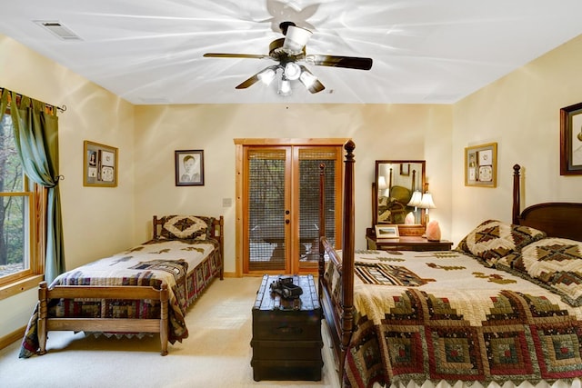 carpeted bedroom featuring visible vents, baseboards, access to exterior, and a ceiling fan