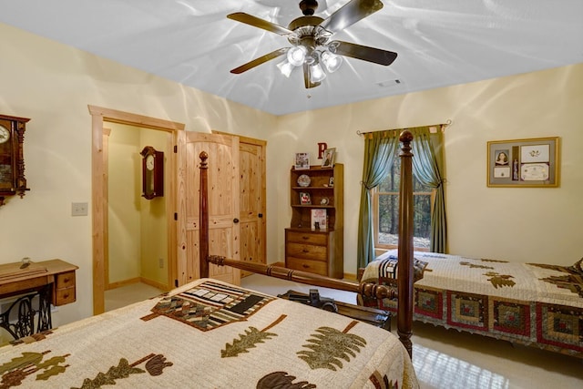 carpeted bedroom featuring visible vents and ceiling fan