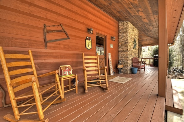 wooden deck with area for grilling and covered porch