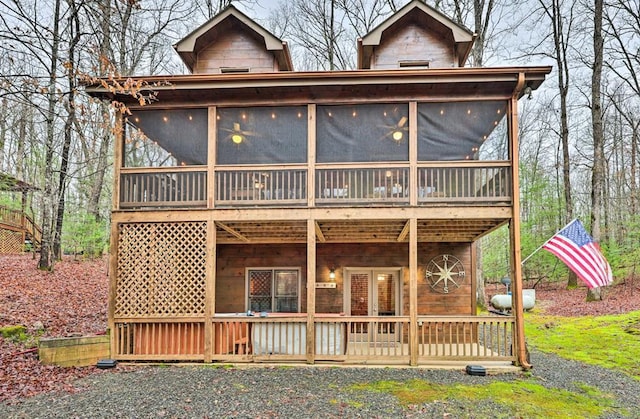 rear view of house featuring a sunroom