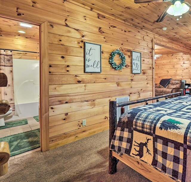 carpeted bedroom featuring ceiling fan, wooden ceiling, and wood walls